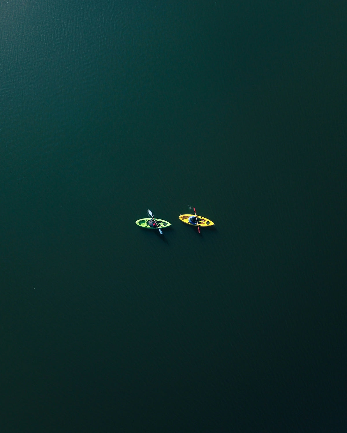 two people riding on two kayaks