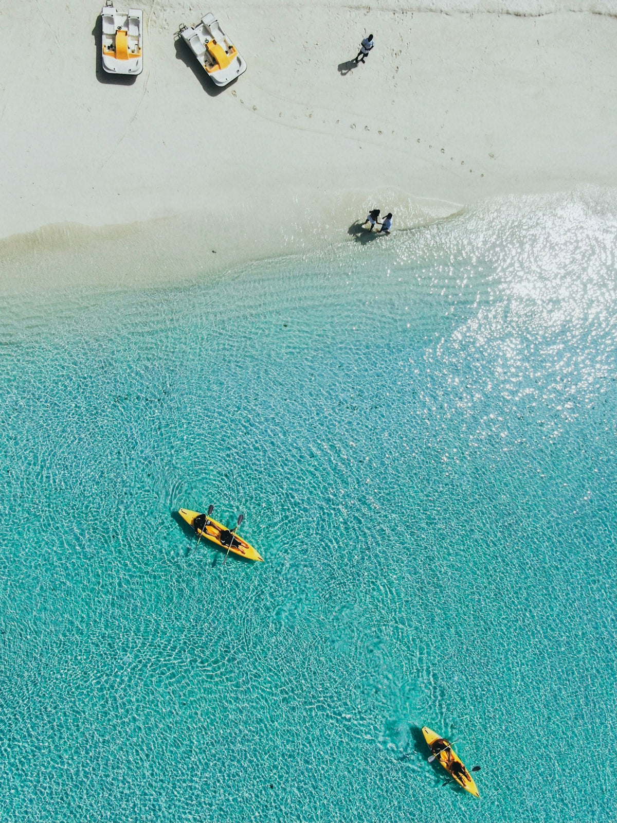 people riding on yellow kayak on sea during daytime