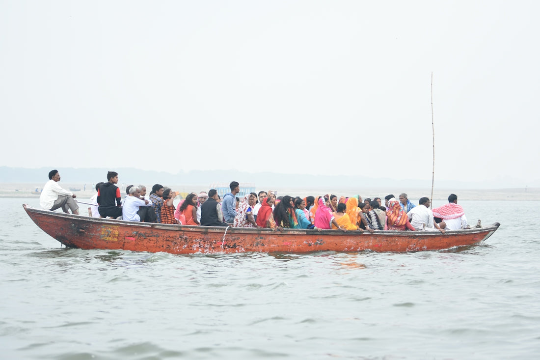 people in red boat on water during daytime