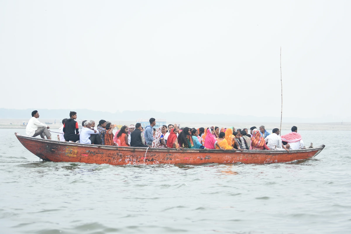 people in red boat on water during daytime