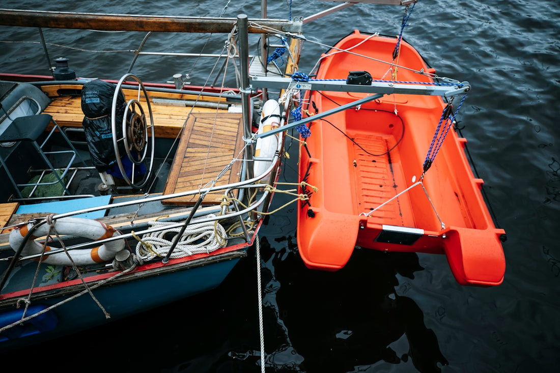 an orange boat is docked in the water