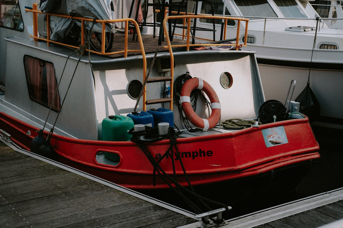 a red and white boat docked at a dock