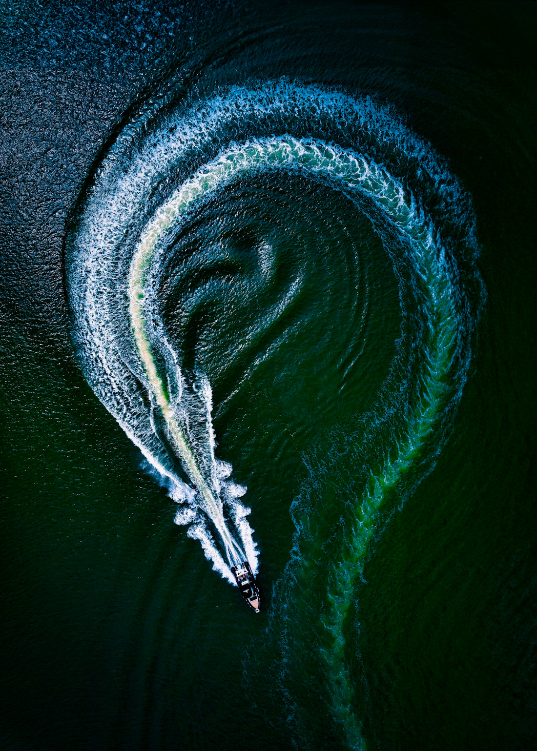 an aerial view of a boat in the water