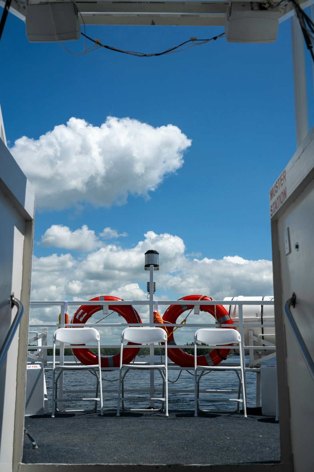 a couple of white chairs sitting on top of a boat