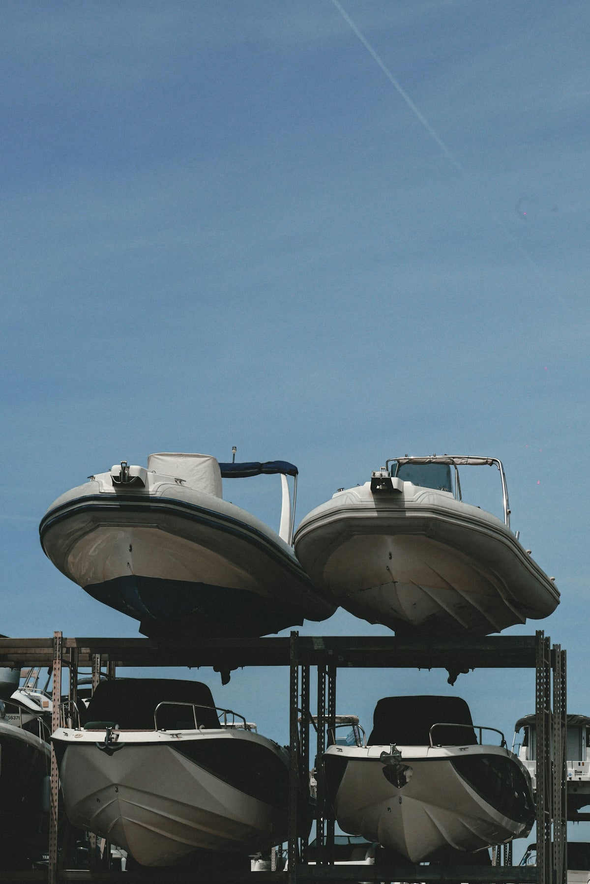 a couple of boats sitting on top of a metal rack