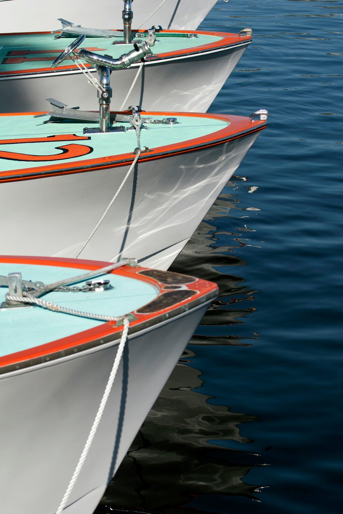 A row of white boats sitting next to each other