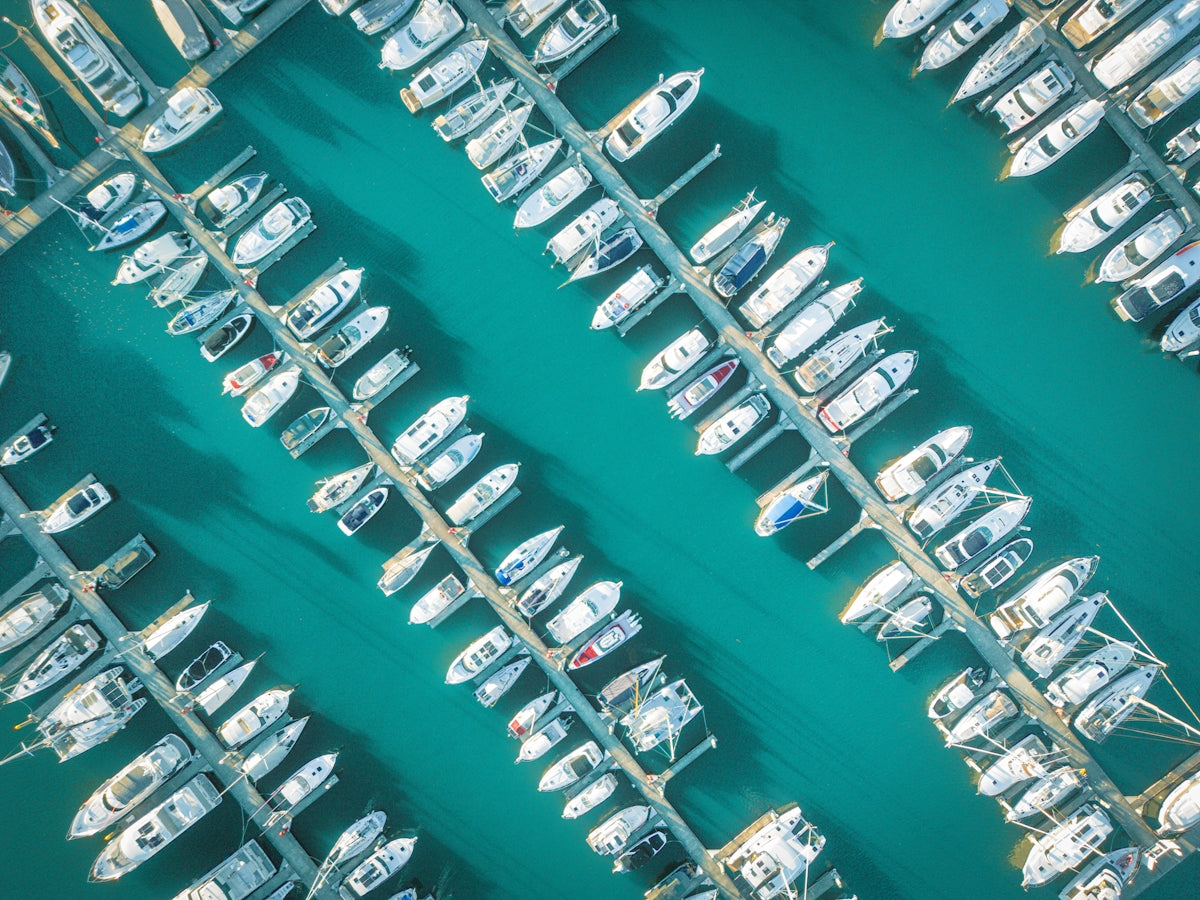 Boats are docked in a marina from an aerial view.