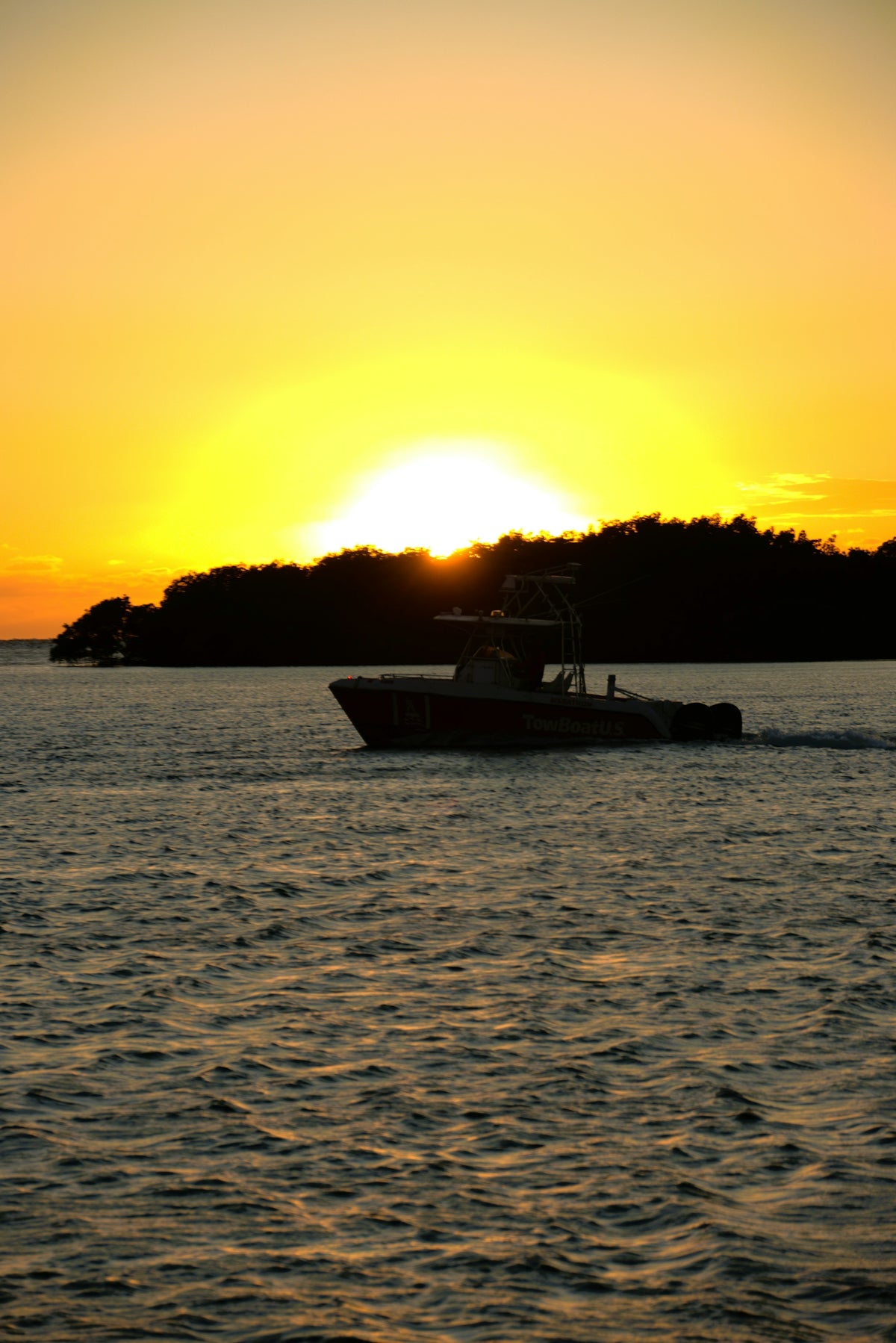 Boat sailing on the ocean at sunset