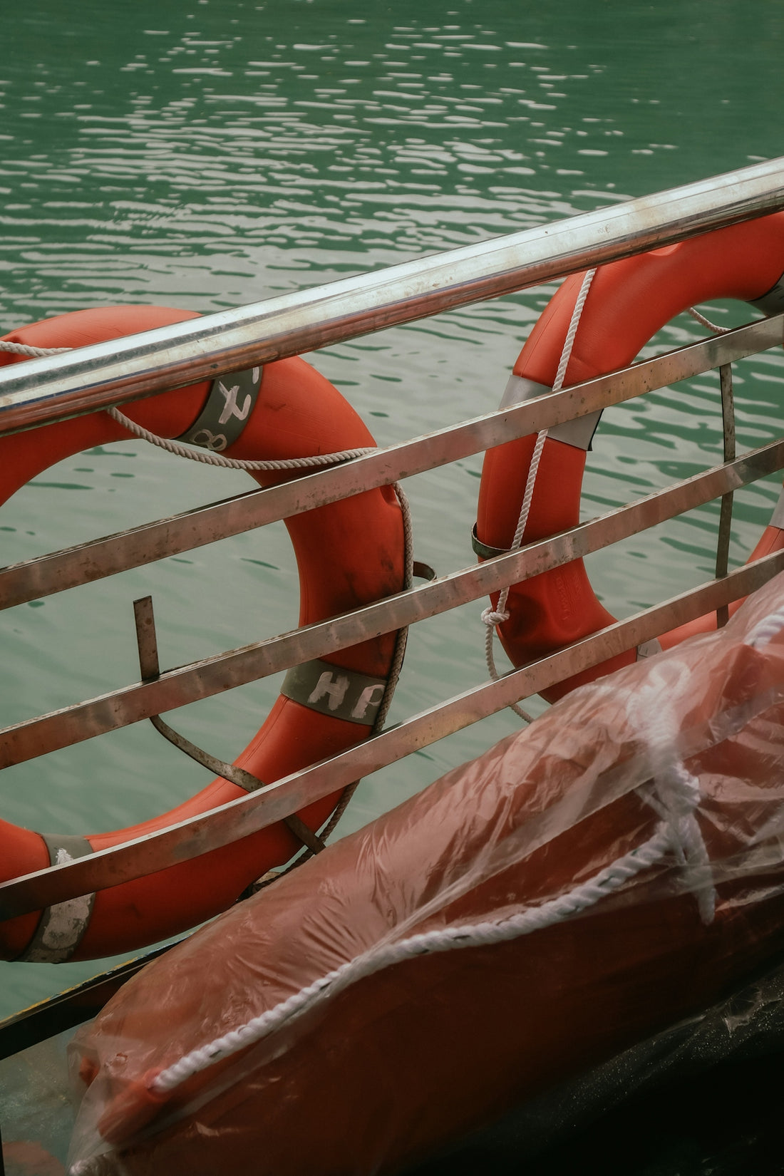 Orange life preservers on a boat railing